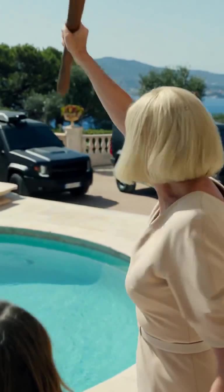 Sylvie raising the weapon just as armored SUVs breach the driveway