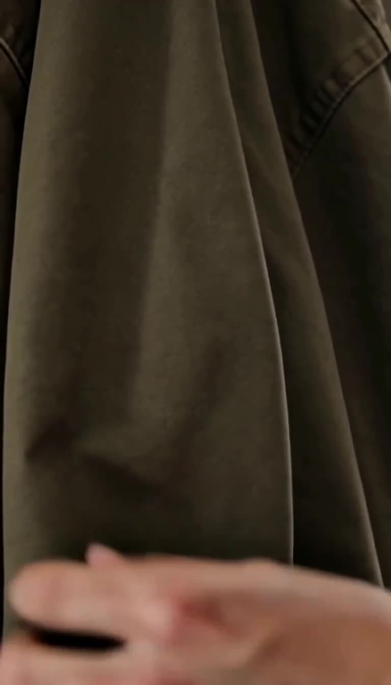Extreme close-up of the jacket fabric concealing the blinking red camera indicator