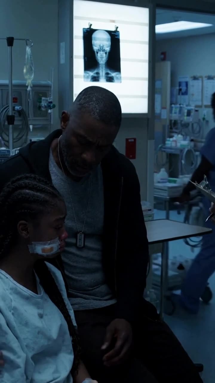 Marcus kneels down beside Lily's hospital bed, his steel dog tag visible beneath his shirt.