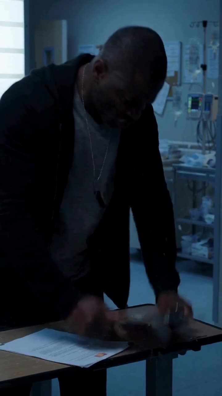 Marcus smashing the broken clipboard down onto the examination table