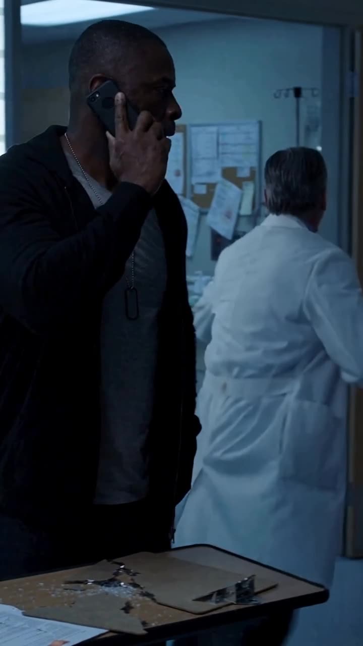 The physician recoiling in terror toward the door as Marcus stands firm beside the hospital bed.