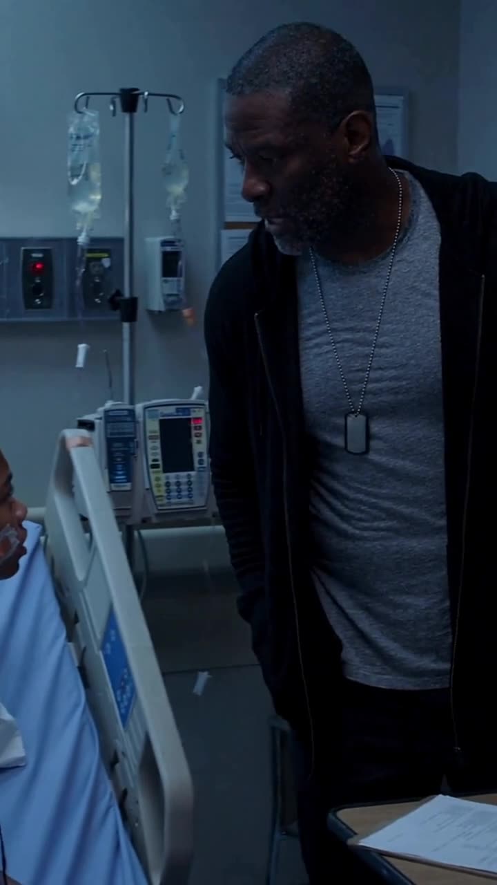 Marcus standing over injured Lily in her hospital bed with an intense, focused expression