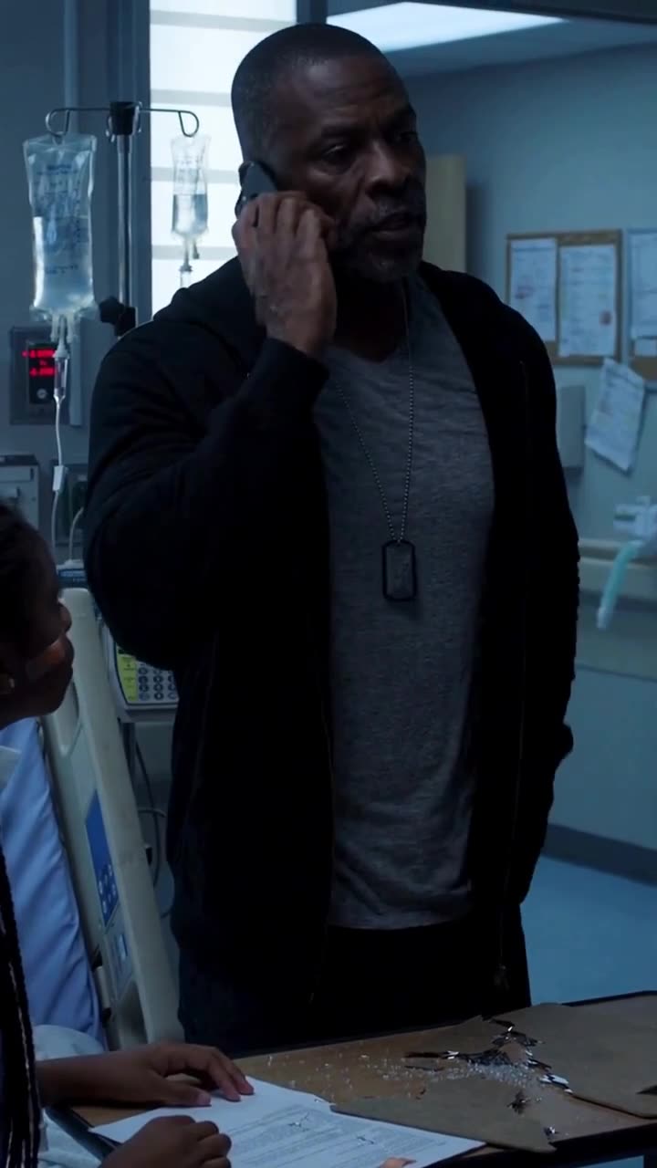 Daniel Mercer makes an urgent phone call with military dog tags visible around his neck.