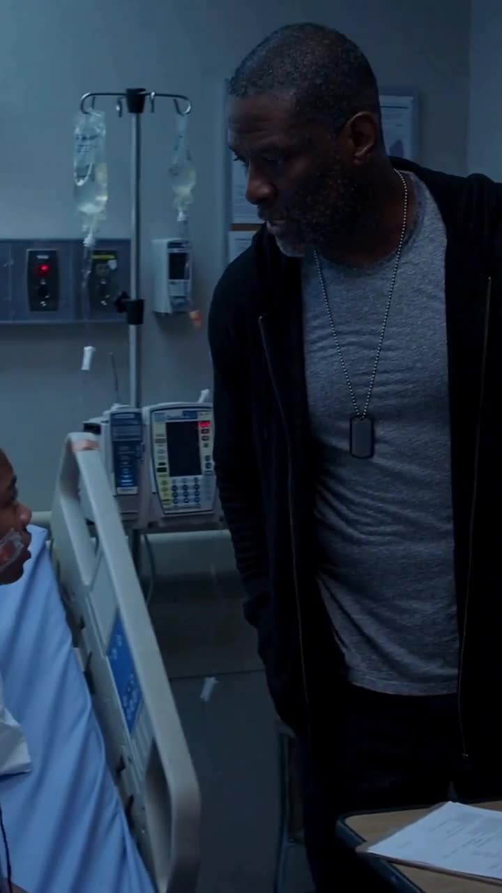 Daniel Mercer leans down to comfort his injured daughter resting in a hospital bed.