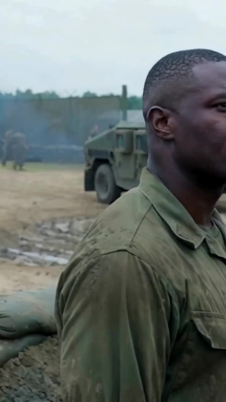 Miller turns in stunned disbelief as armored military vehicles storm the compound.