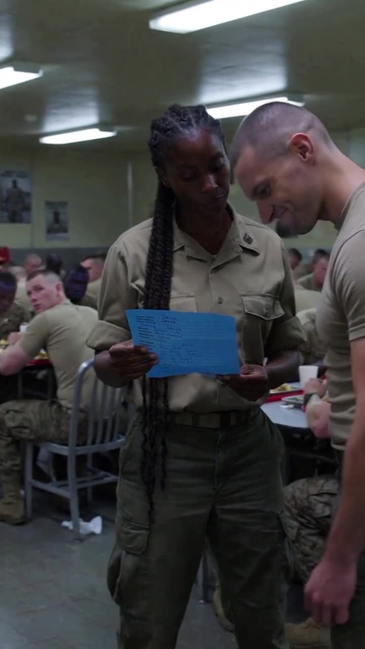 Derek glaring down as Maya calmly reads through the documented misconduct report