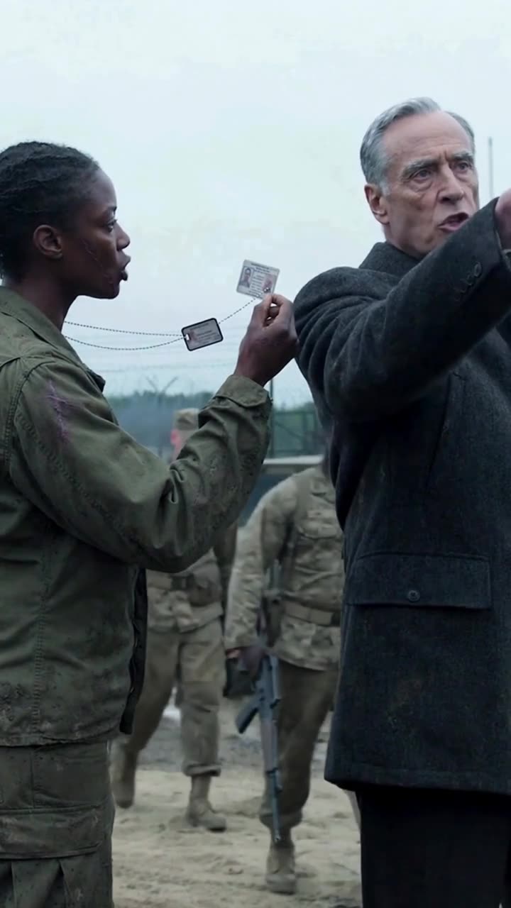 Maya brandishes her credentials before Marcus as Donald raises his hand to signal approaching armed military escorts.