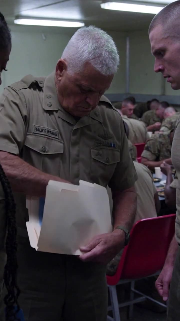 Commander Robert reaches into his tan folder to draw out recovered official forms.