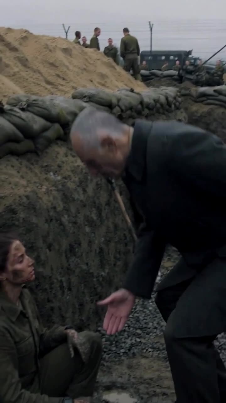 An elder official bends down into a muddy fortification trench, reaching out his hand to help the fallen soldier.