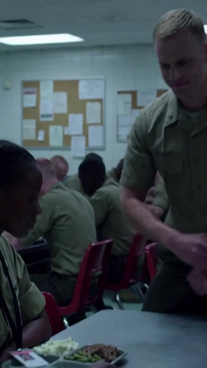 Sergeant Brad leans over the mess hall table as his smirk begins to fade.