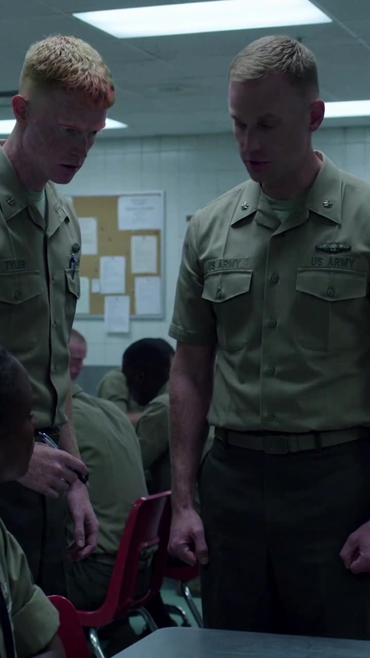 Sergeant Brad and Corporal Tyler stand rigidly at attention staring down at the identification card.