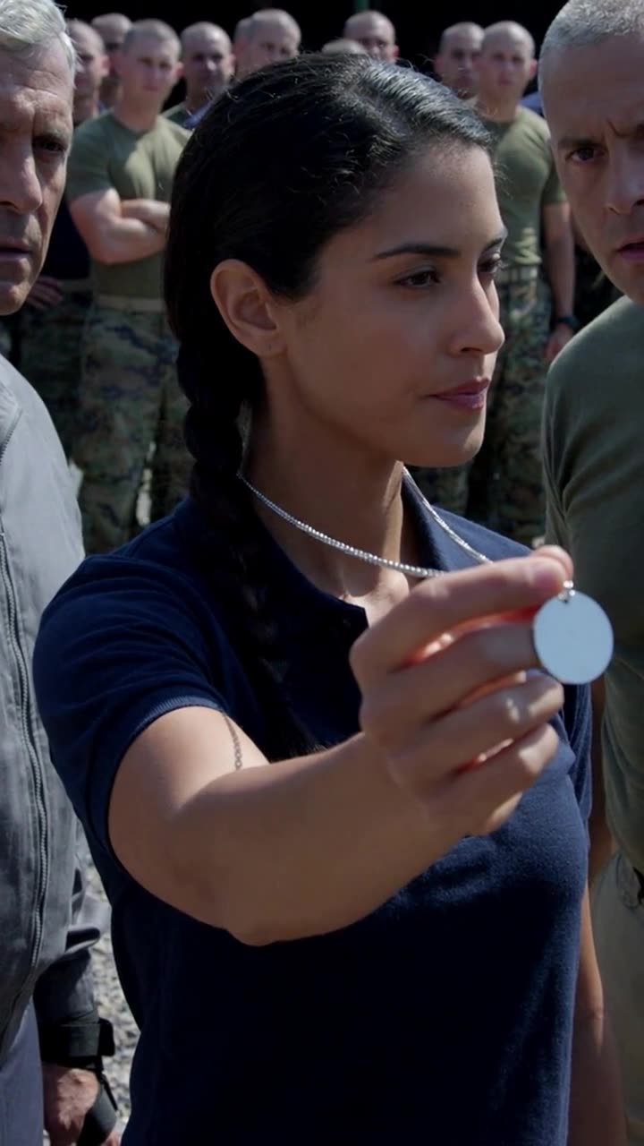 Camille extends the polished steel inspection medallion toward the stunned drill commanders.