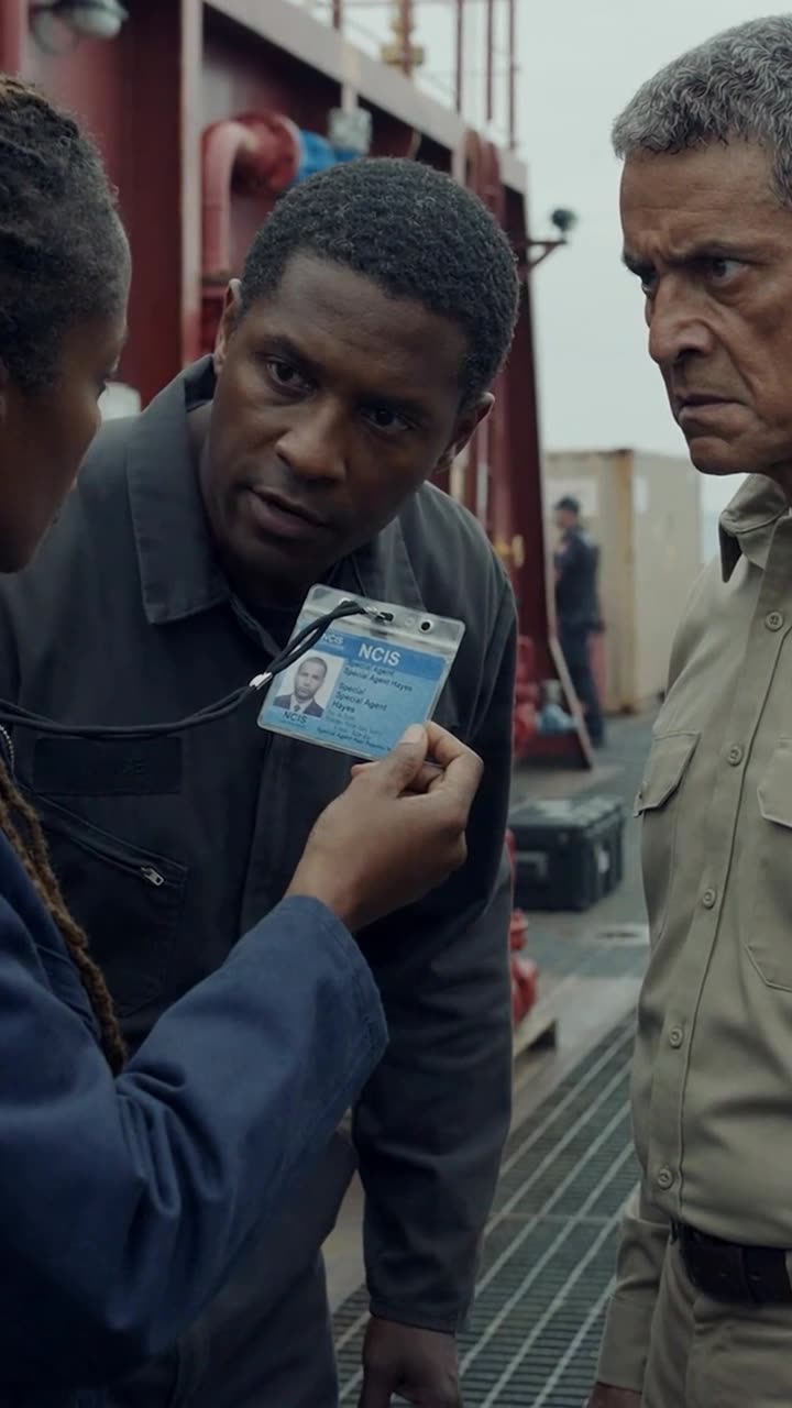Thomas examines the NCIS credential closely, confirming the federal warrant as Vance glares in silence.