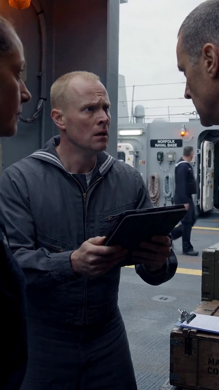Toby anxiously delivering an urgent command order to Robert and Maya