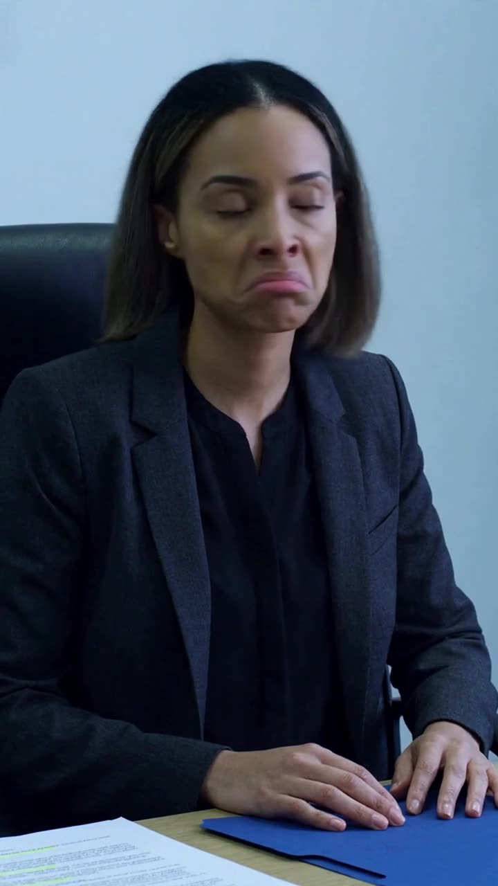 Chloe winces in visible dismay after her attempt to dismiss a colleague backfires.