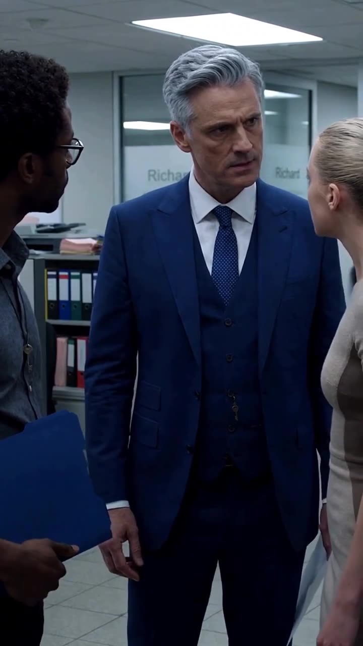 The executive sternly confronts a rival candidate in the hallway after the sabotage.