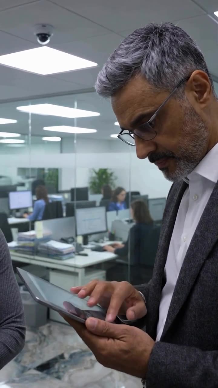 The CEO reviews surveillance footage on a tablet computer