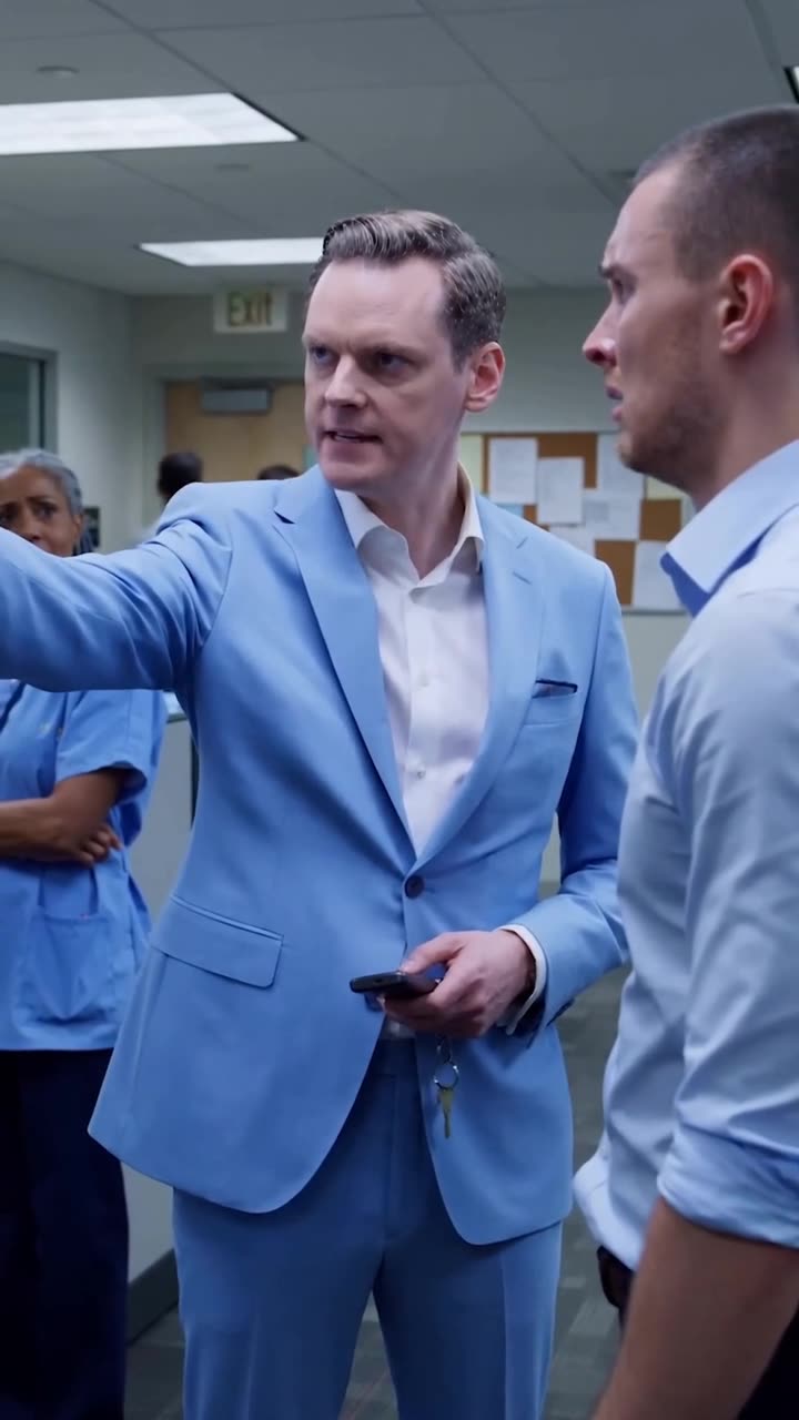 Julian pointing firmly toward the exit while commanding Tyler to leave the office immediately.