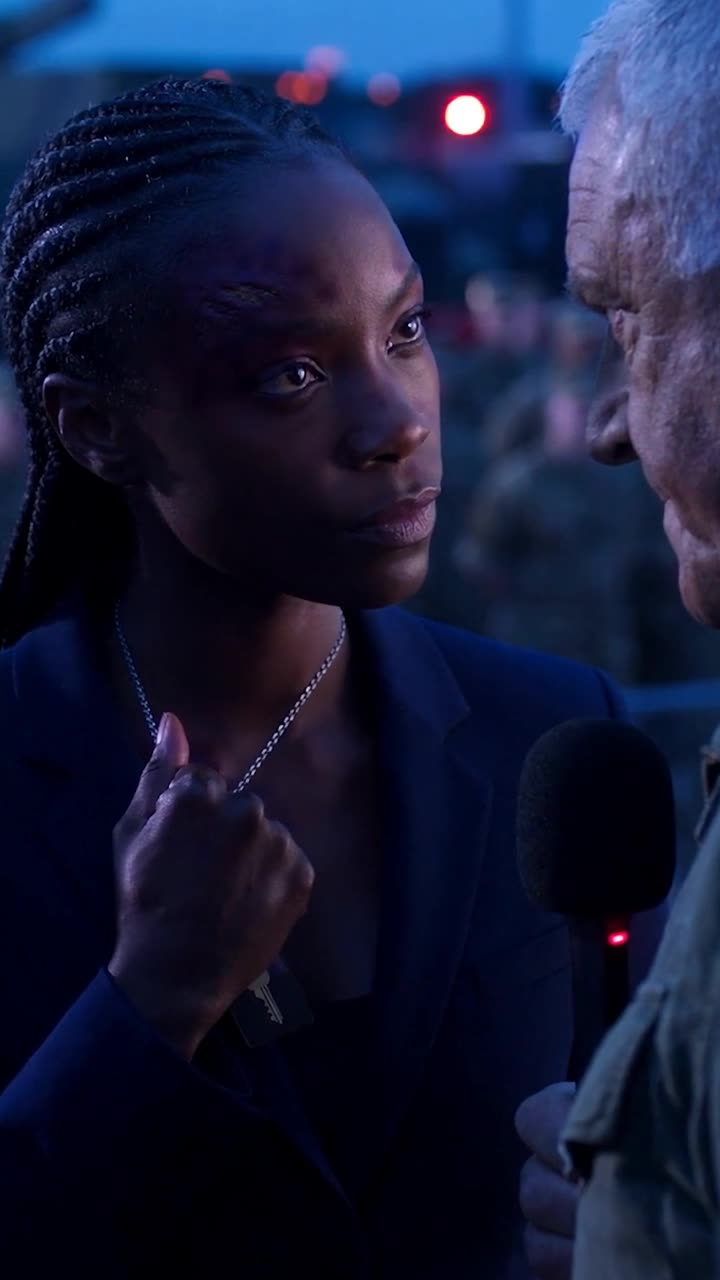 Maya pulls a hidden clearance card from her collar with a steely glare