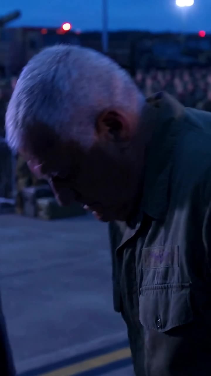 A defeated military officer bows his head in humiliation after receiving the dismissal notice.
