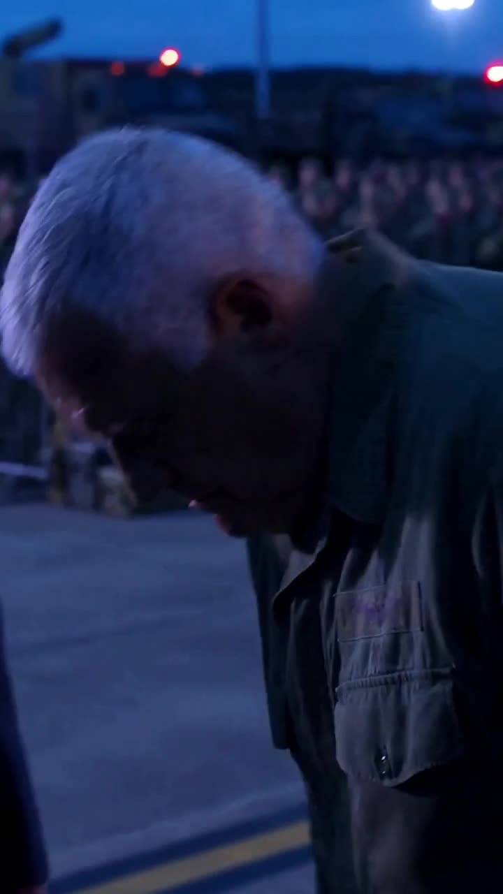 Colonel hangs his head in defeat following his public arrest on the parade grounds
