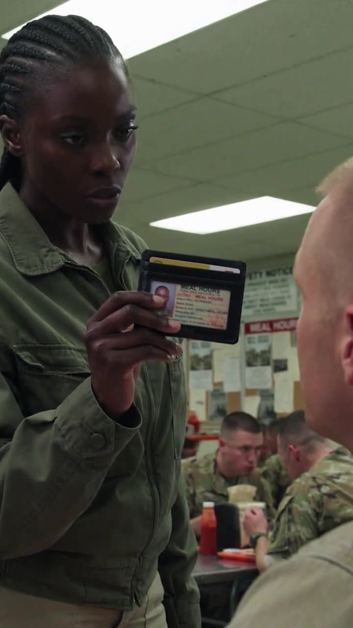 Maya holding her official identification badge directly in front of Brad's face
