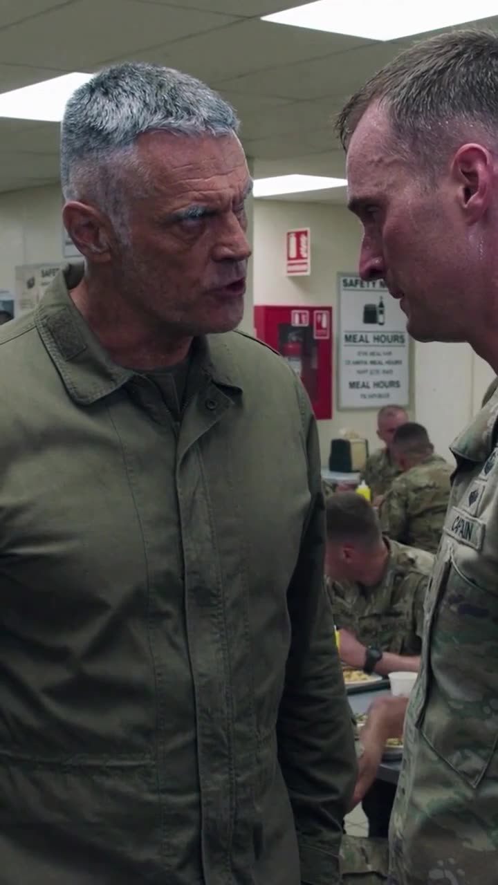 A stern veteran commander gets nose-to-nose with the reprimanded captain as fellow soldiers watch.