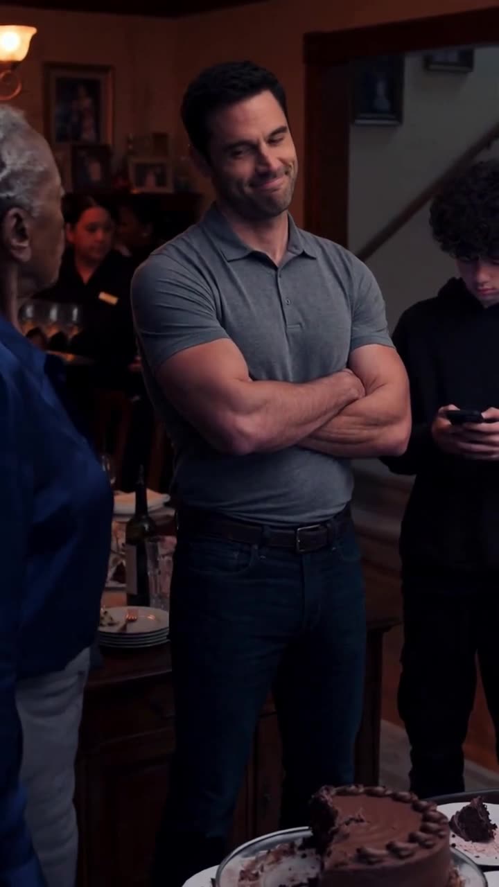 Mark smirks arrogantly with folded arms as Tyler checks his smartphone in the dining room.