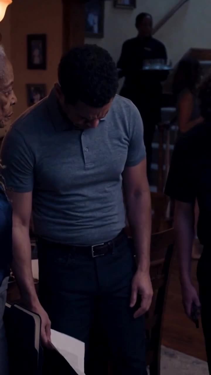A defeated man bows his head in shame as guests look on in stunned silence.