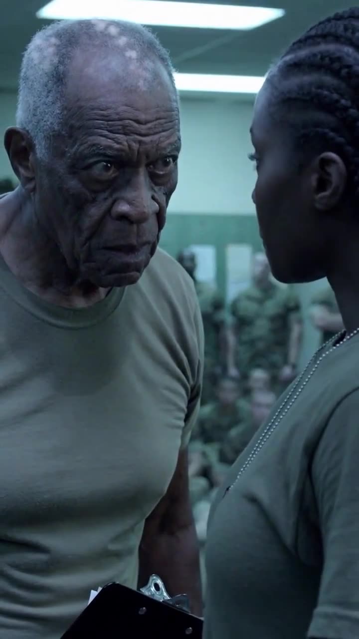 A senior military drill instructor staring intensely in disbelief at Samantha Miller
