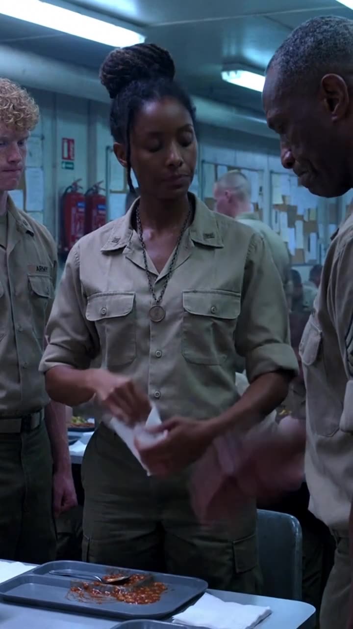 Sarah wipes her uniform sleeve with a napkin after Marcus snaps into a rigid military salute.