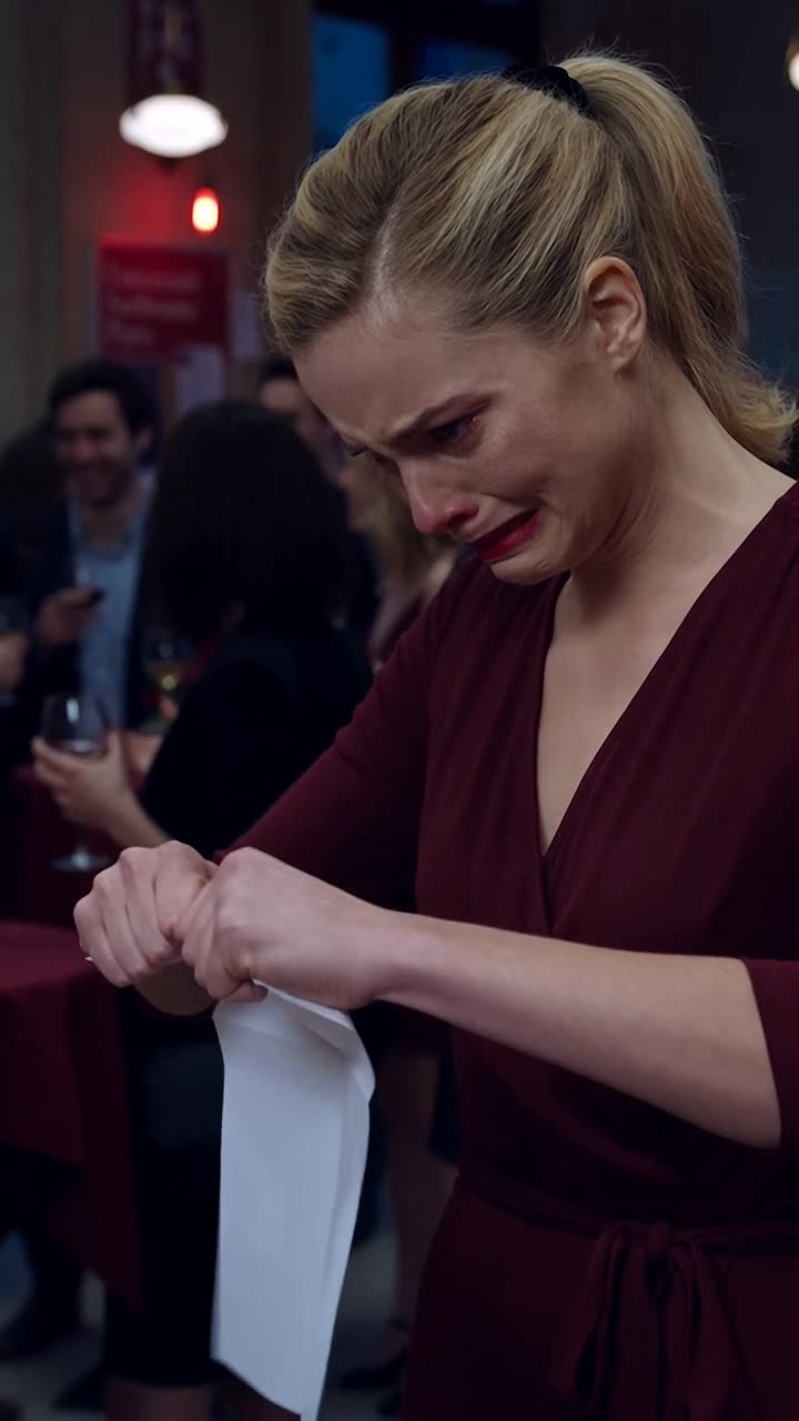 Chloé aggressively tears the document in half with a tense, vindictive expression.