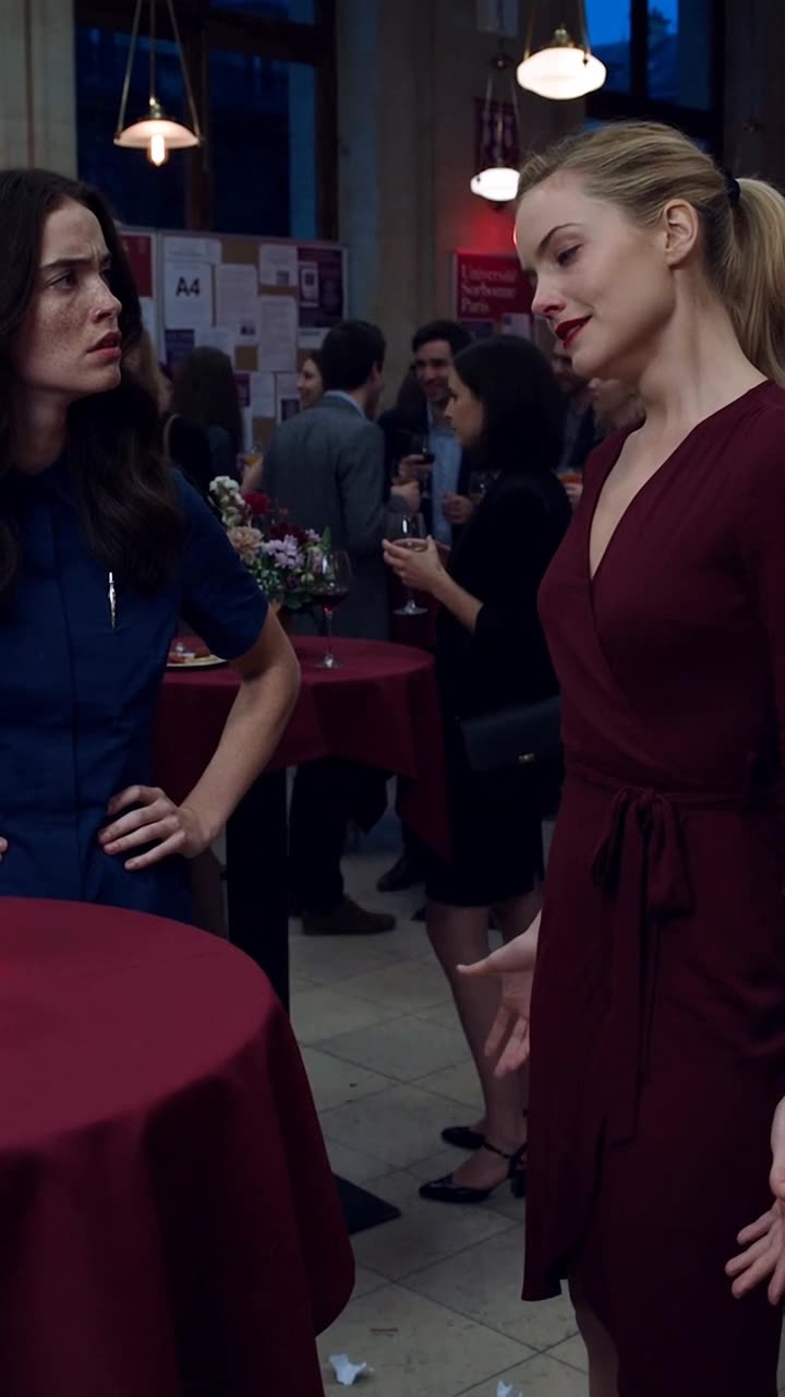 Camille confronts Chloé as the torn pieces of the letter drop to the floor.