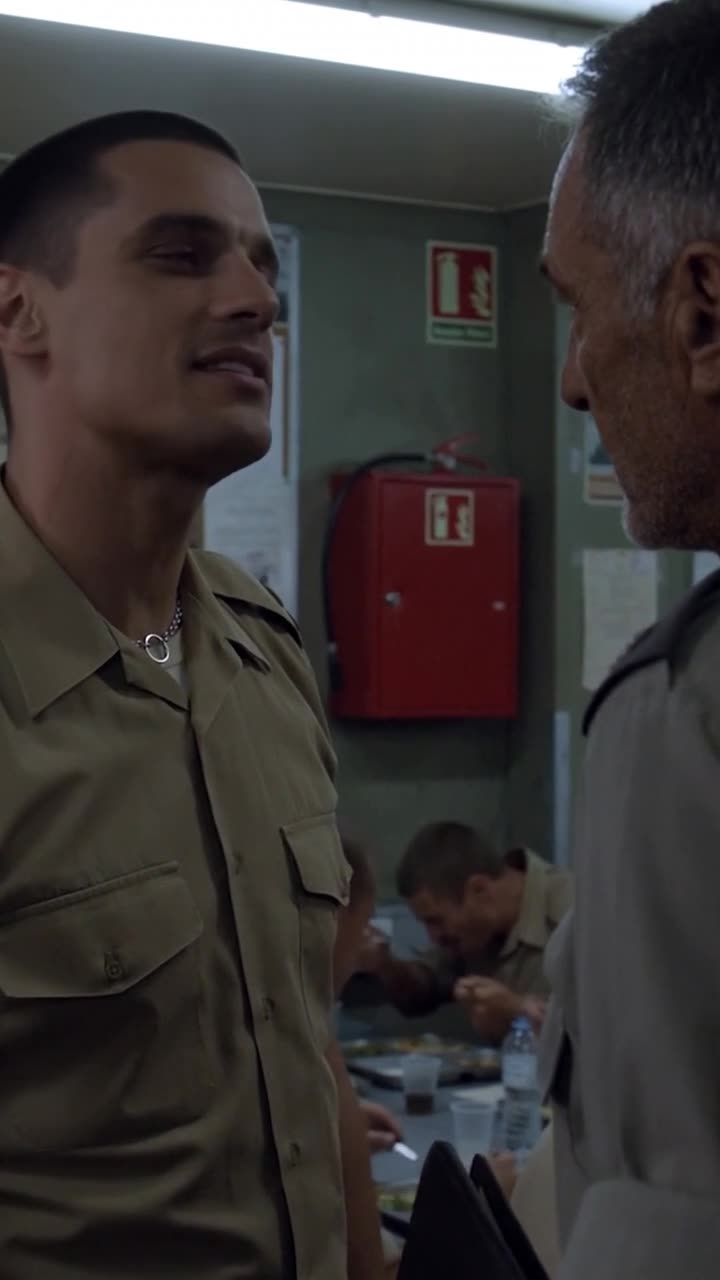 Julien sneering arrogantly as he speaks to General Henri during the tense mess hall confrontation.