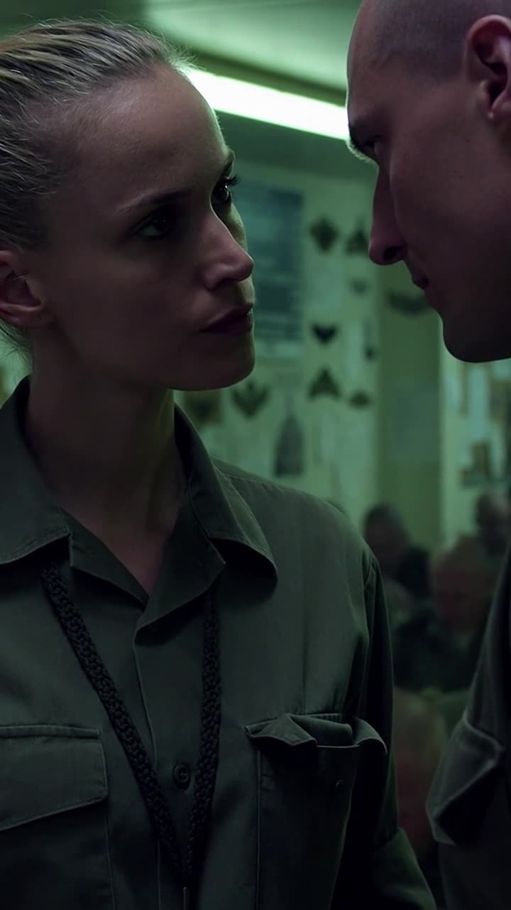 Élodie staring directly at Sergeant Maxime after exposing her superior command badge.