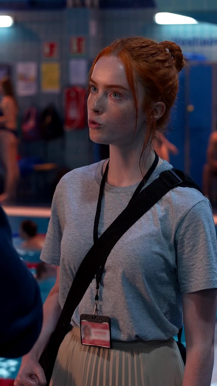 Camille glares back defiantly, displaying her lanyard pass as she orders Maxime away.