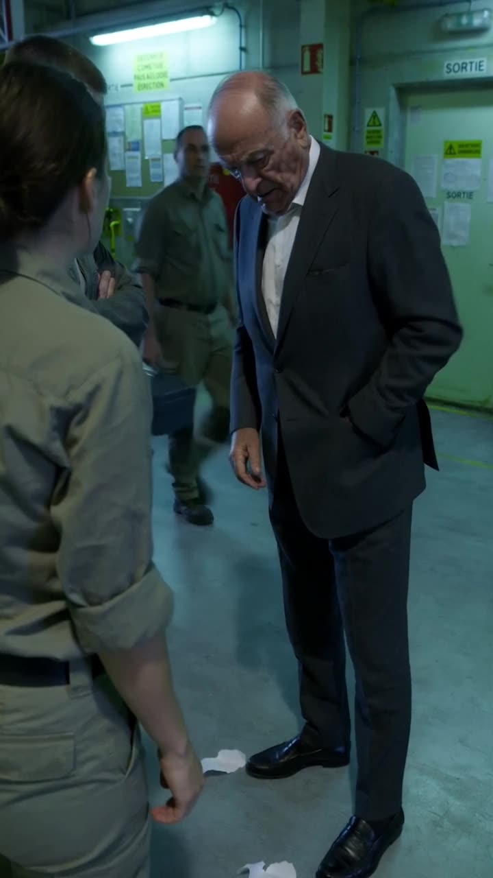 Philippe drops the shredded permit onto the floor and reaches inside his tailored suit jacket.