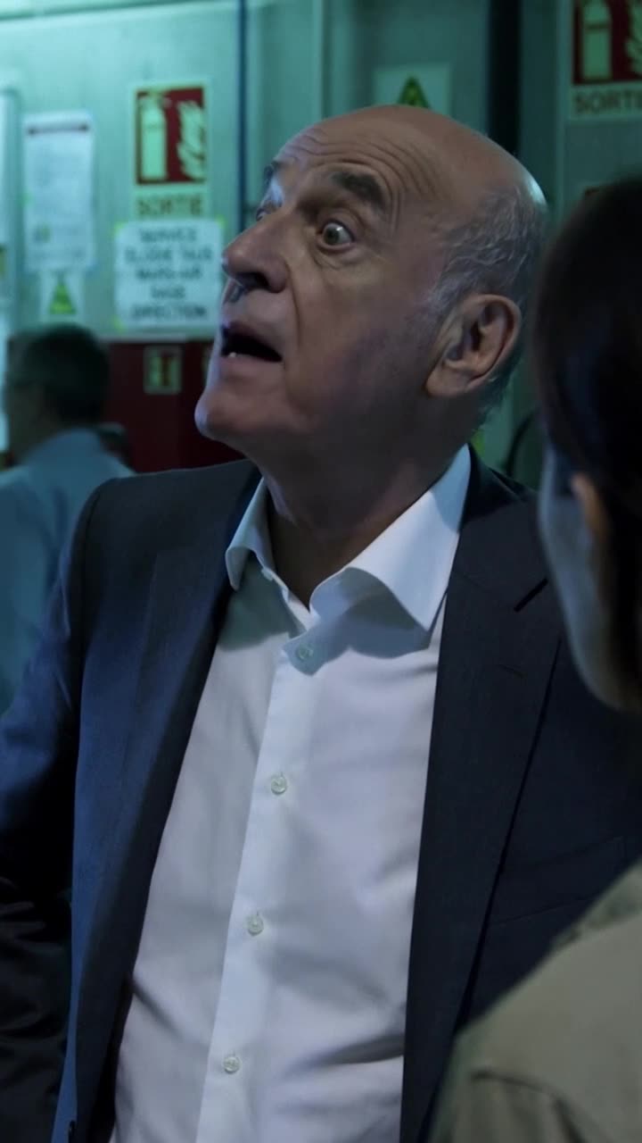 Philippe's mouth falls open in shock and disbelief upon recognizing the inspector's identity.
