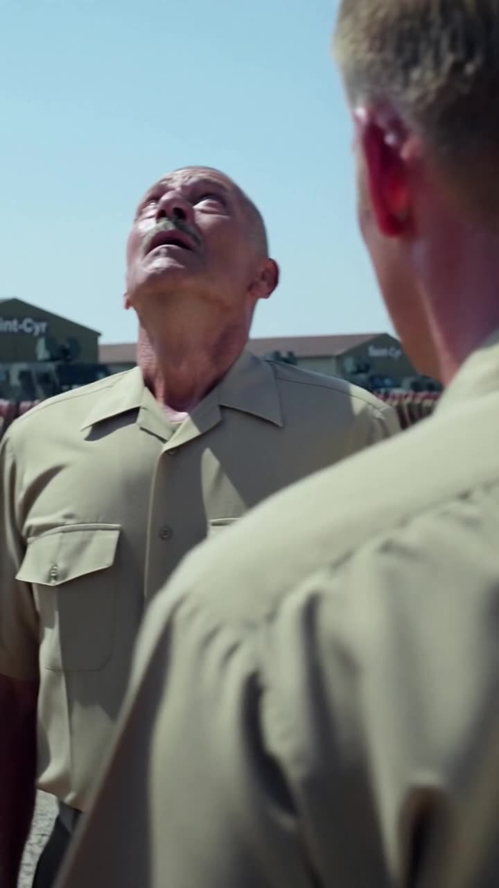 Maxime watching over Philippe's shoulder as the veteran officer gasps in shock