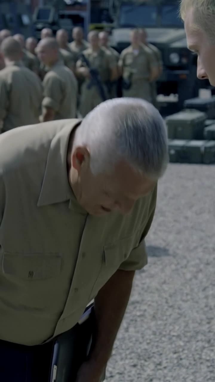 Philippe abruptly bows his head in deep deference before Camille on the gravel yard.