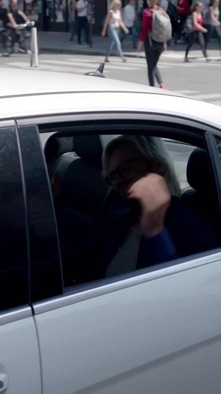 The triumphant suspect grins smugly from inside the car before realizing the engine won't start.