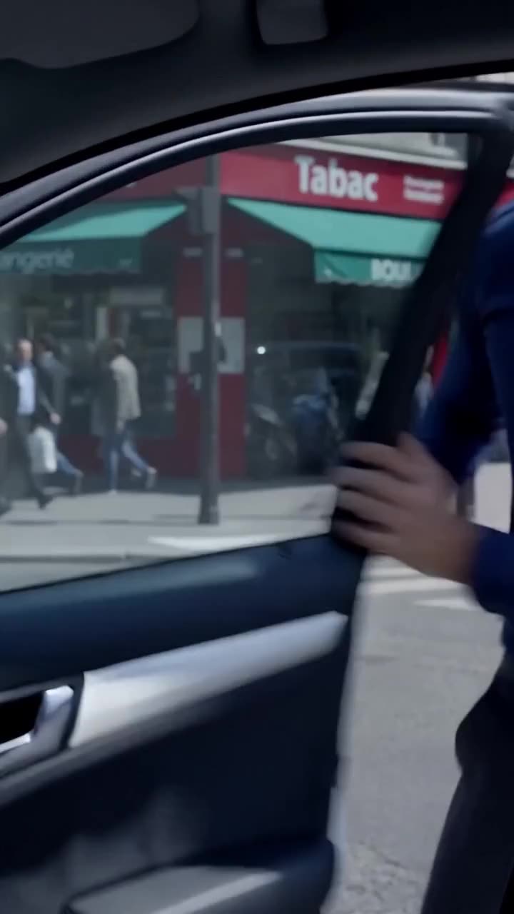 A car door swinging open along a Parisian avenue during the altercation