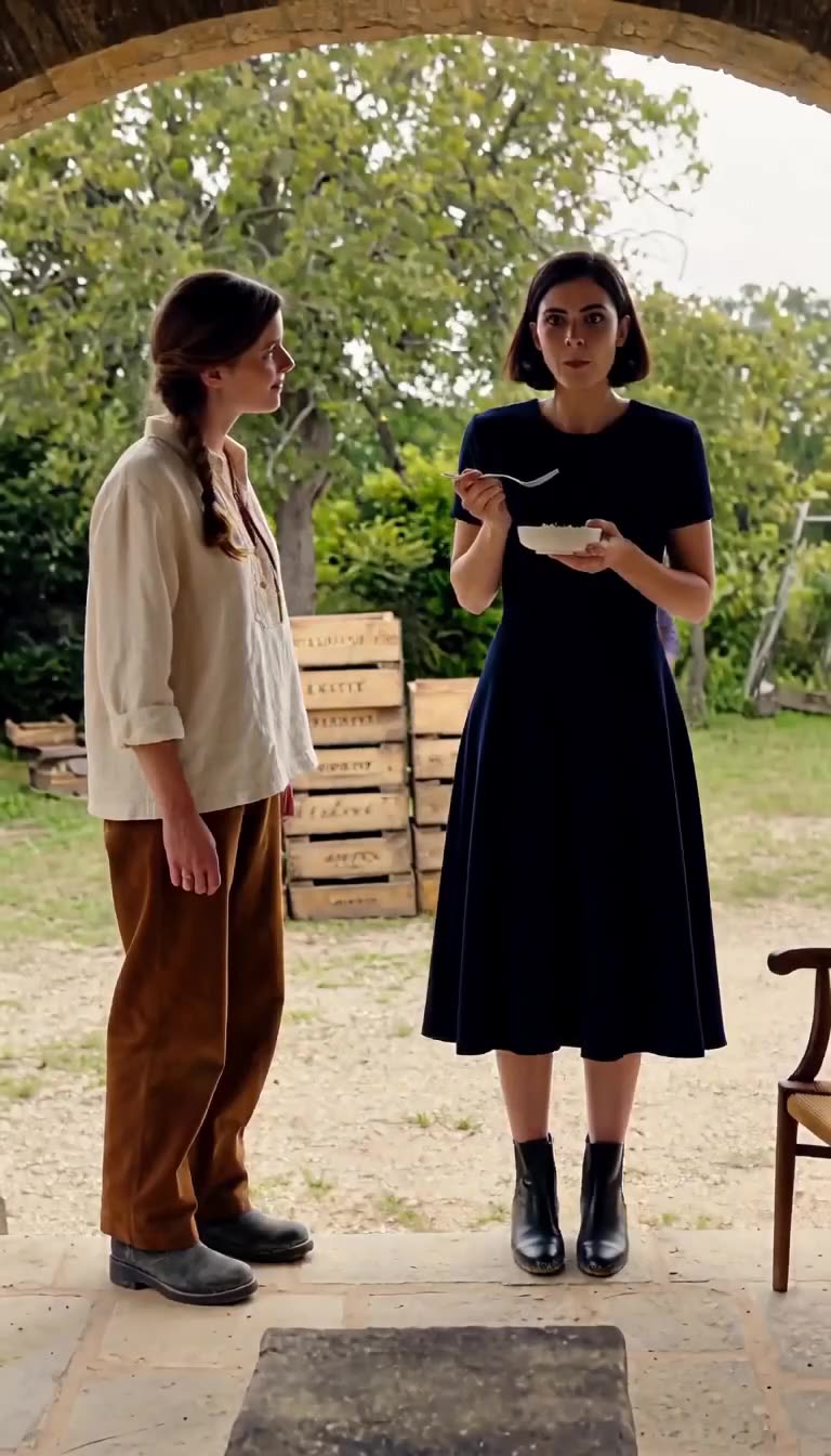 Inès stands stunned by the exquisite flavor as a man carrying a leather folder approaches behind her.