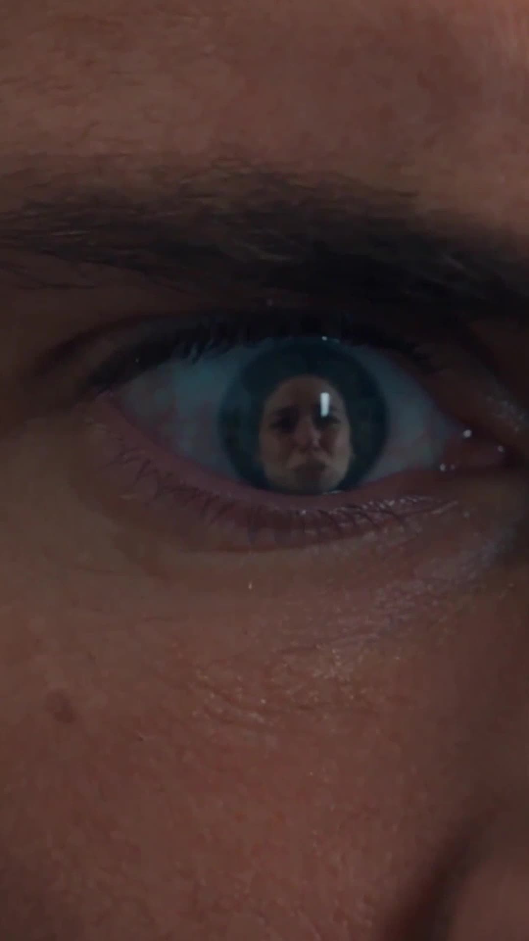 Brandon's eye reflects his wife's desperate, pleading expression.