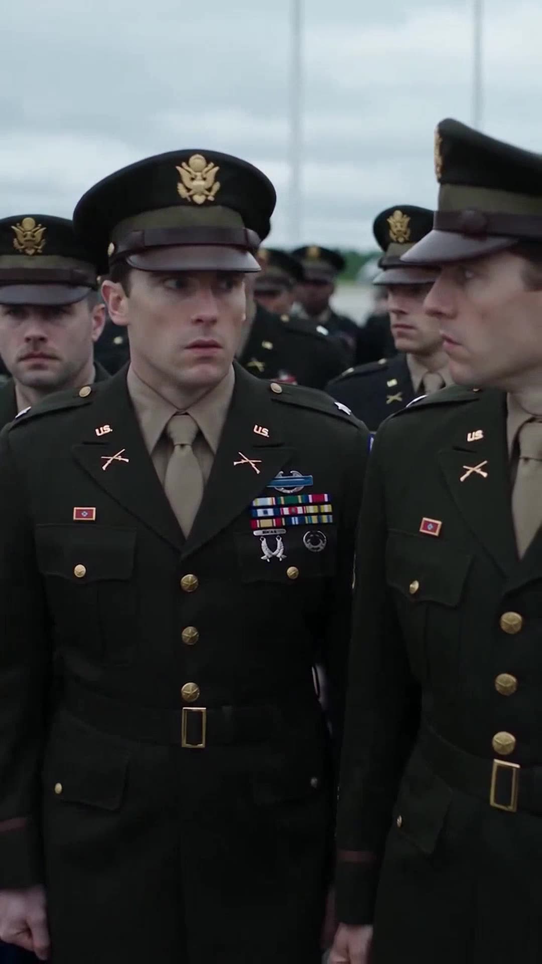 Captain James Miller and other uniformed soldiers looking concerned and uneasy during the confrontation.
