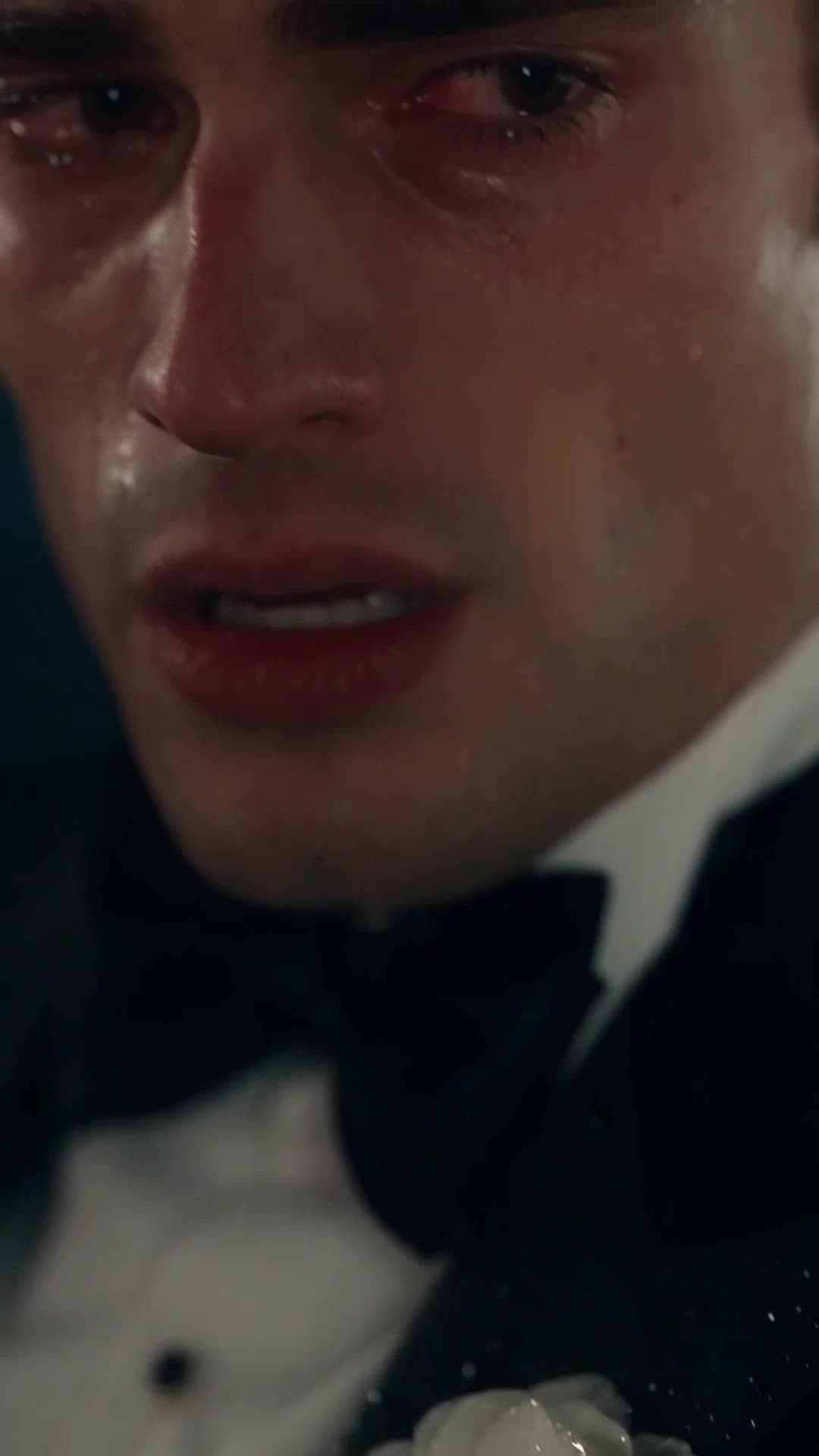 Close-up of a distraught groom in a tuxedo sobbing as he flees his wedding ceremony
