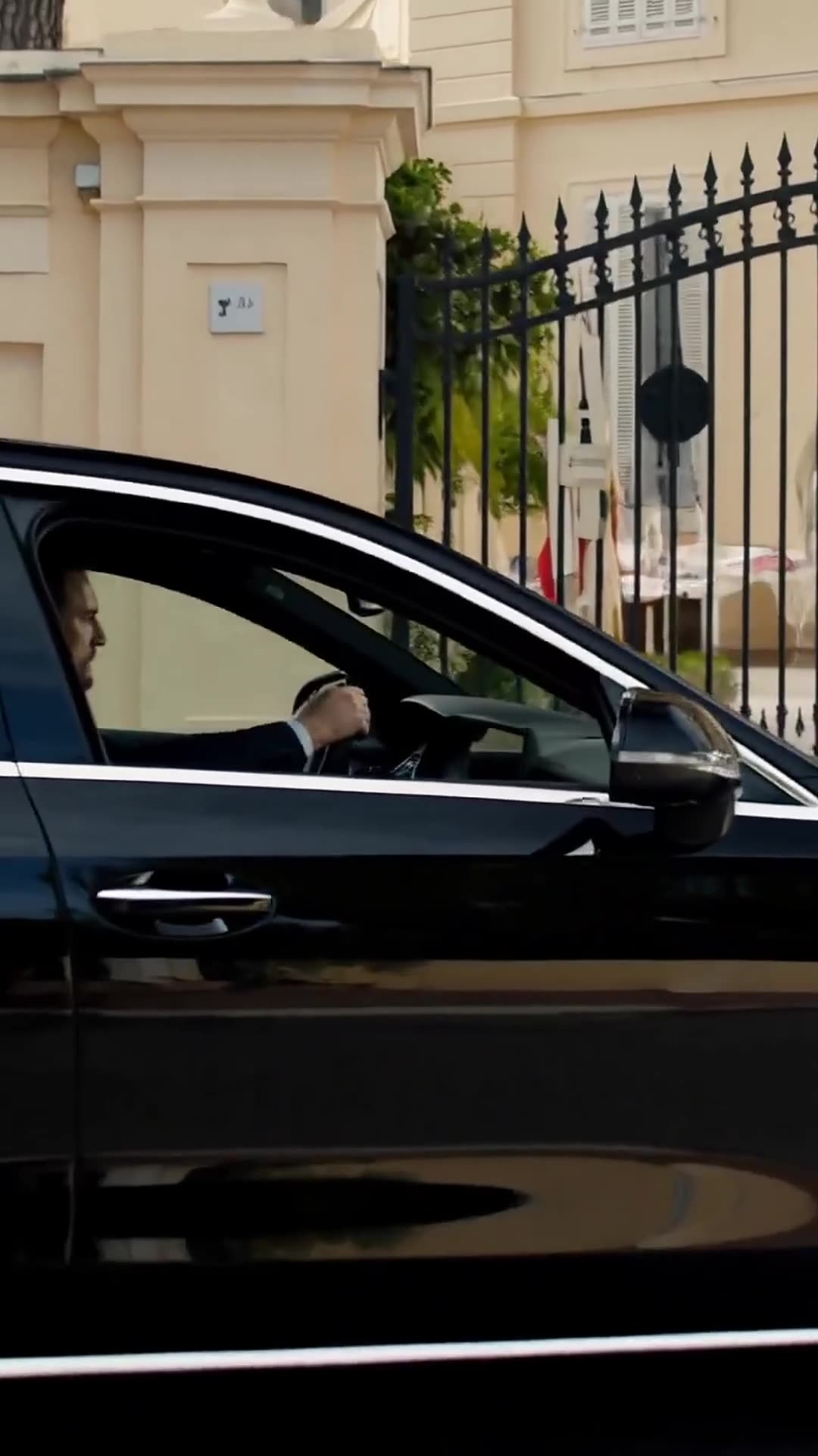 Julien speeds furiously in his luxury car towards the villa after hearing the alarm.